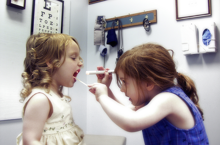 Two little girls playing at doctor
